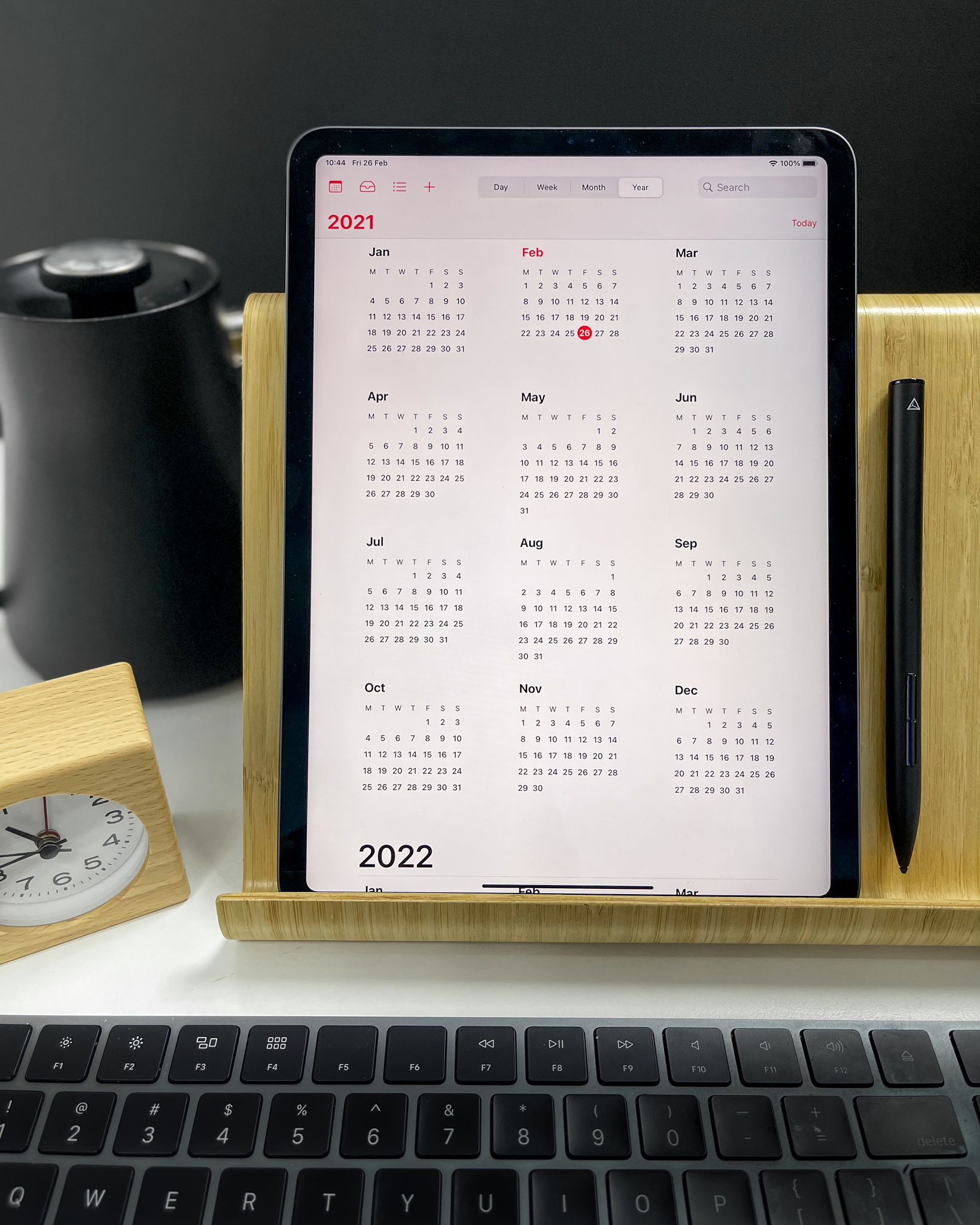 2021 calendar on an iPad in a wooden stand with keyboard