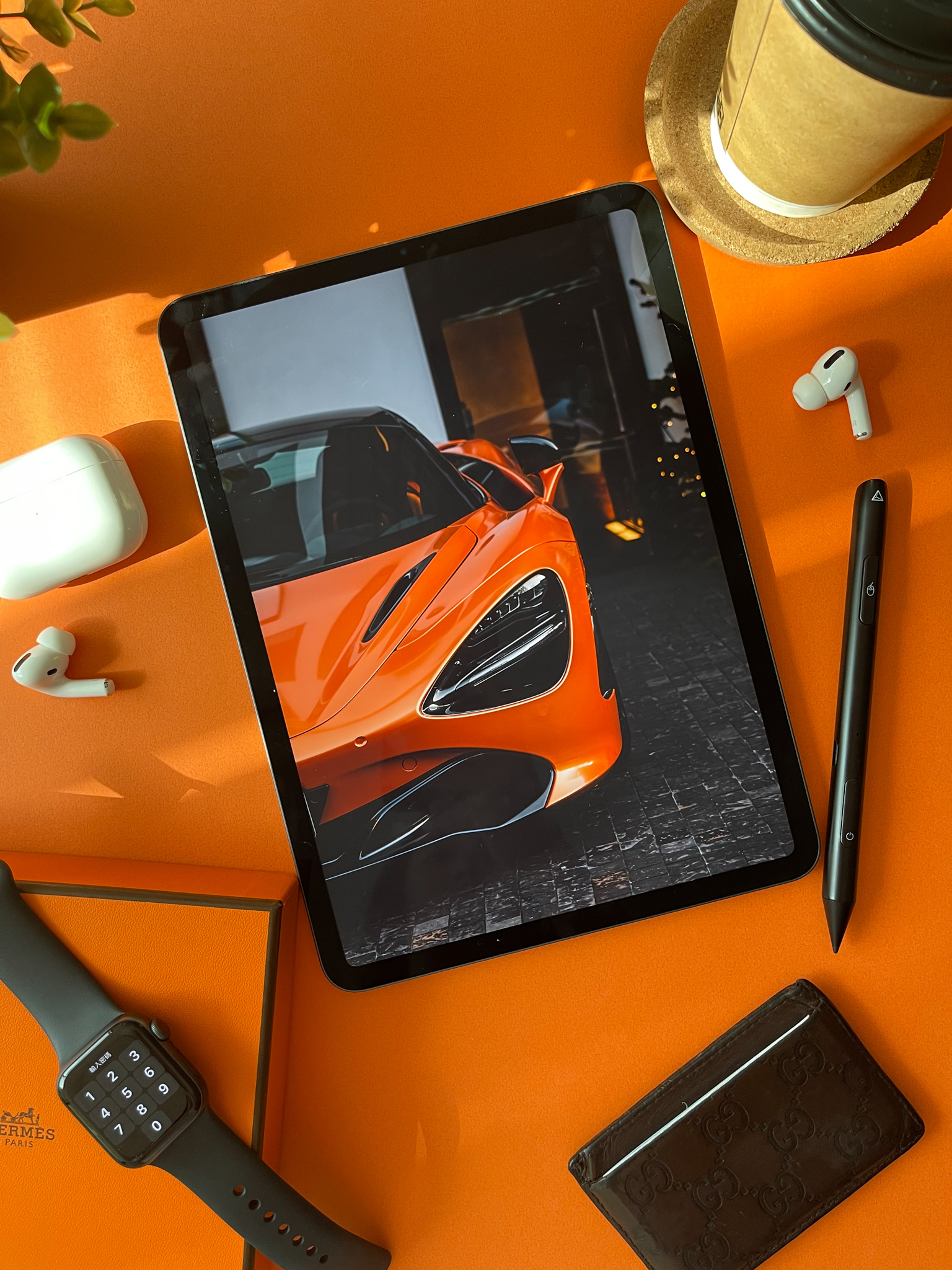 Adonit stylus styled on an orange desk with a McLaren on the iPad screen