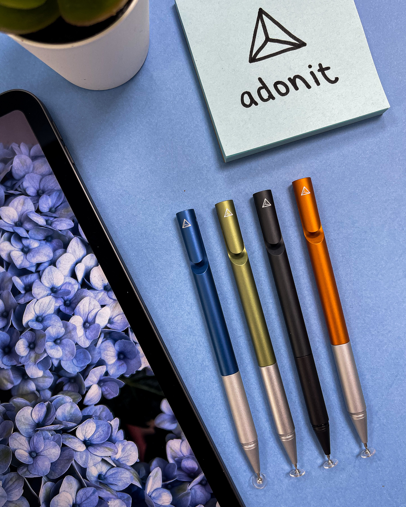 Coloured Adonit pens beside hydrangeas