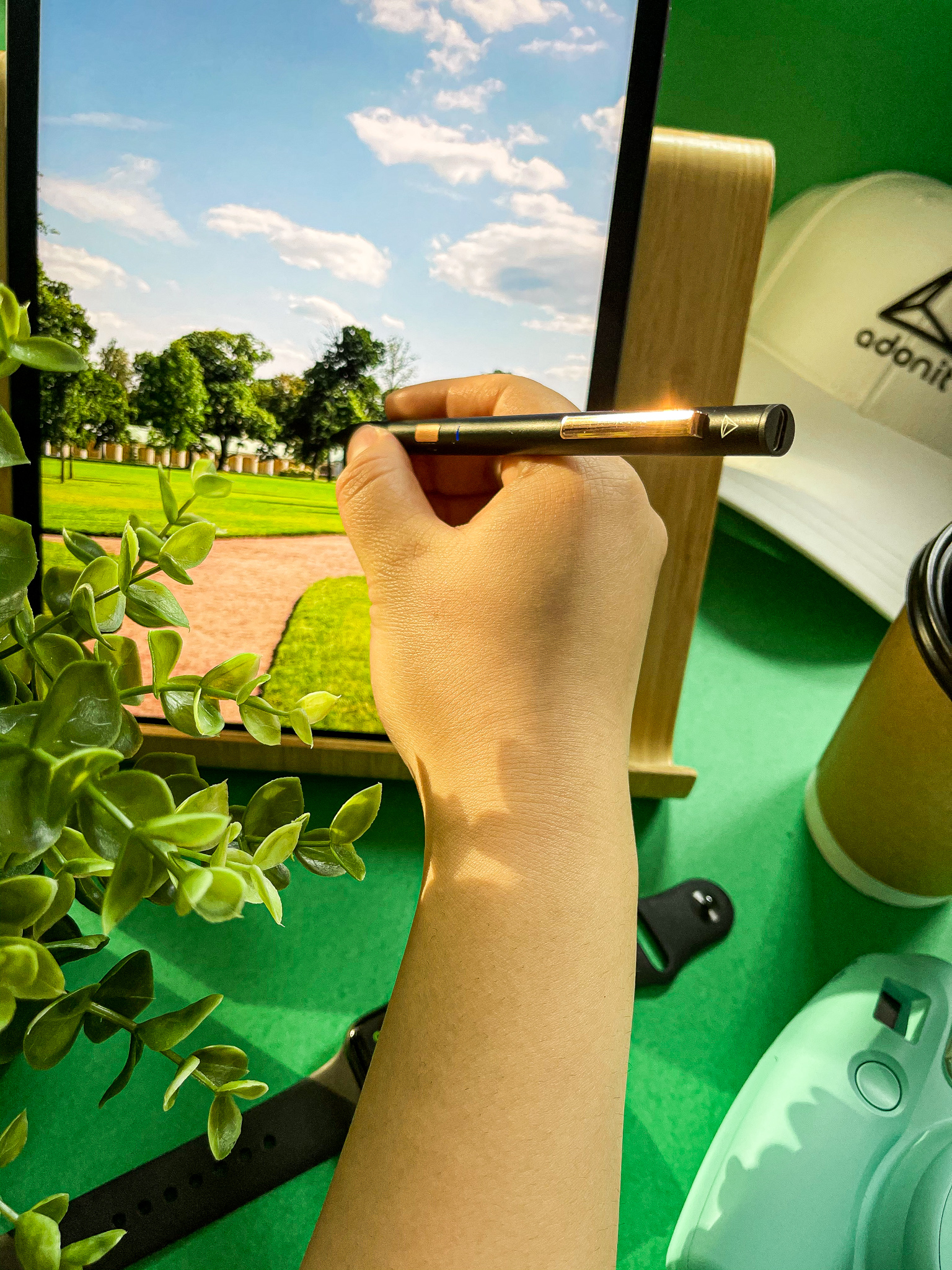 Golf course on iPad with an Adonit cap and coffee