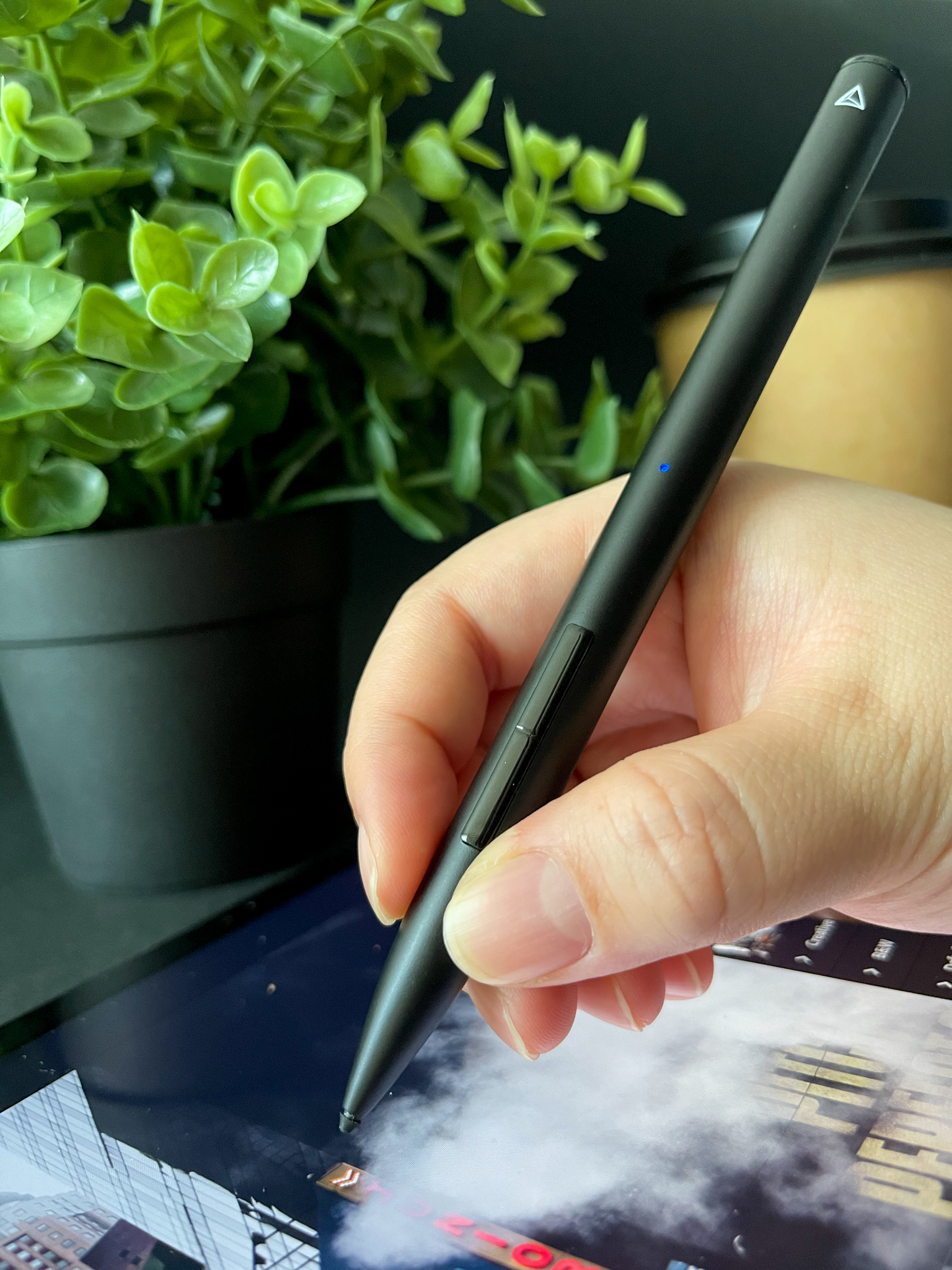 Hand holding the stylus over an iPad edit