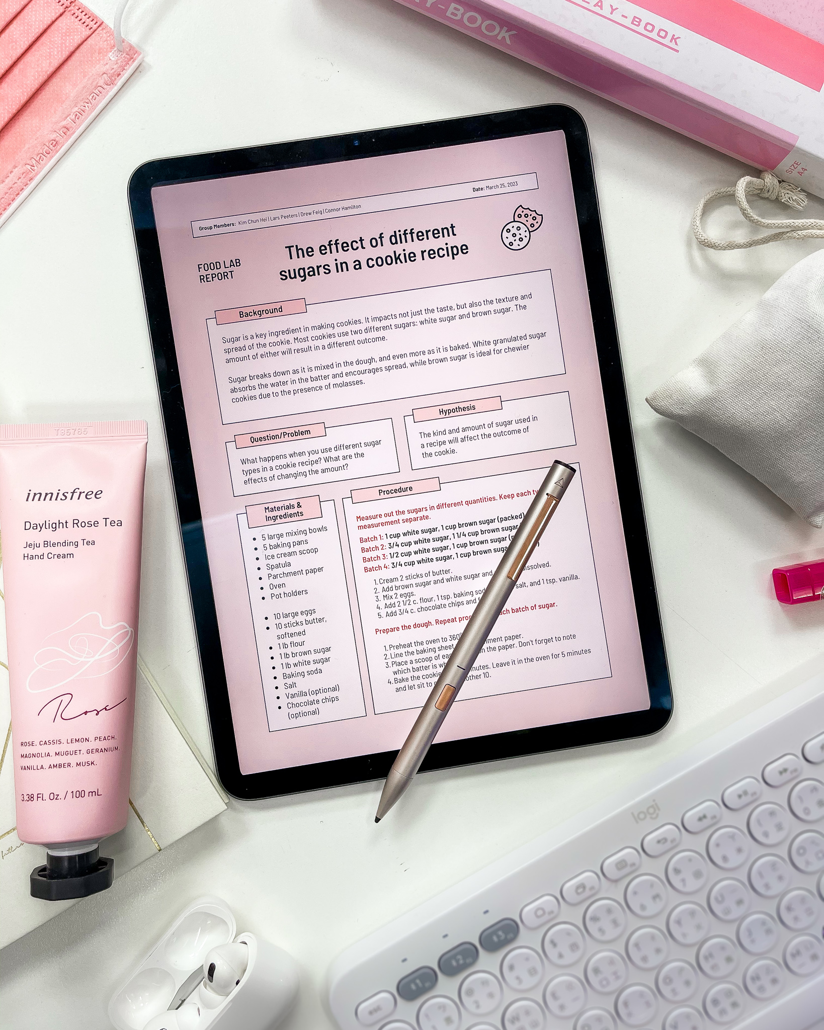 Handwritten notes on iPad, pink desk