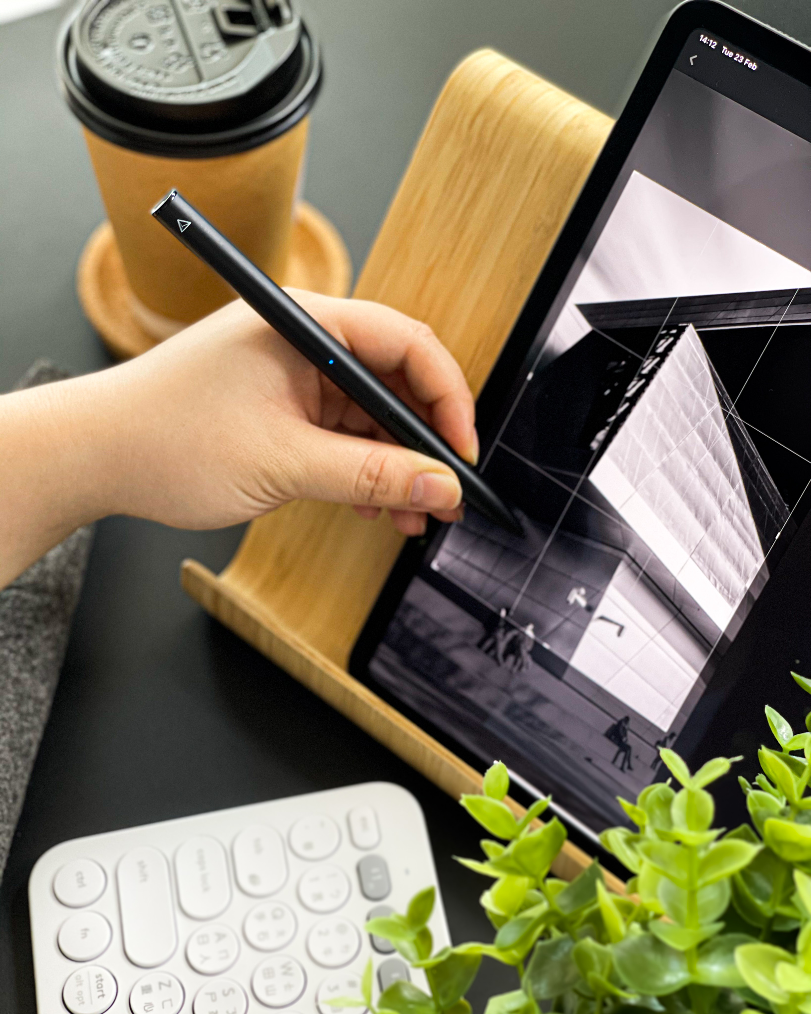 iPad in a stand with keyboard, coffee and stylus