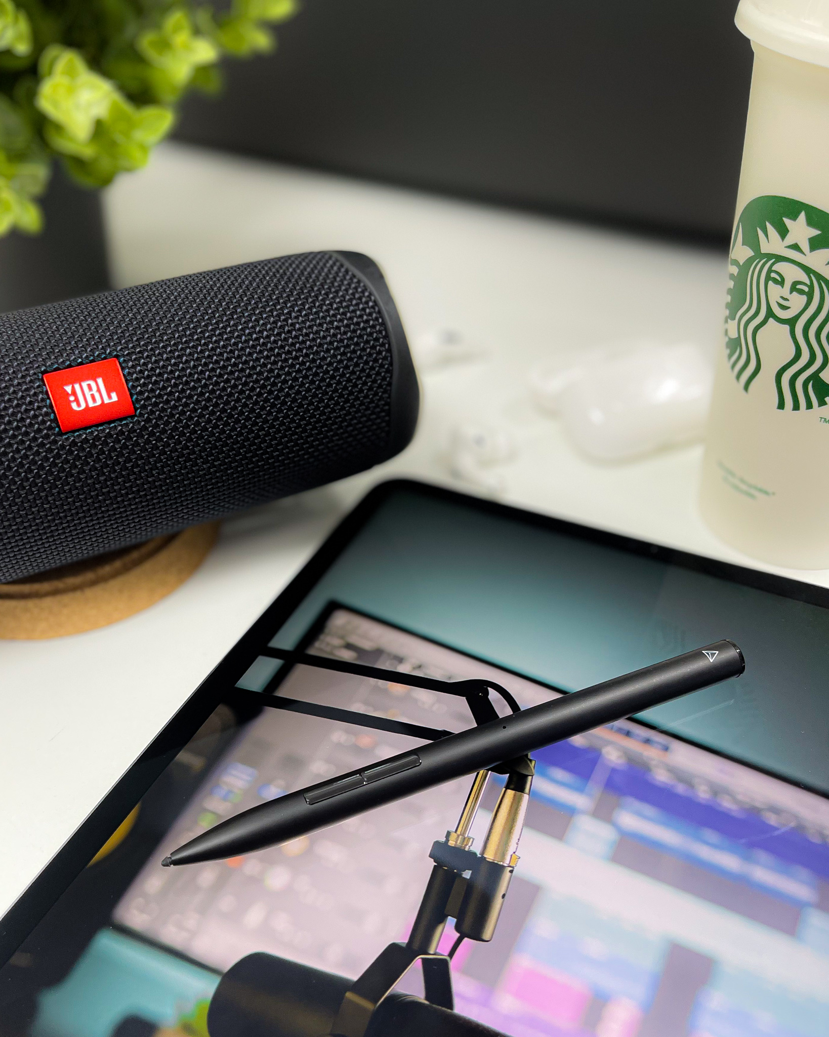 JBL speaker beside an editing screen and stylus