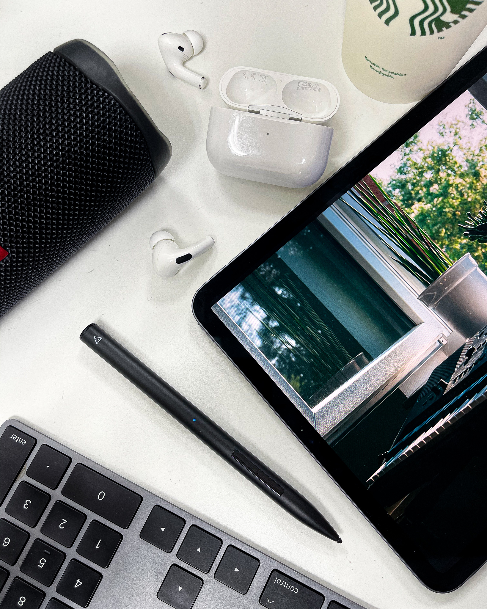 Stylus, AirPods and speaker flat-lay