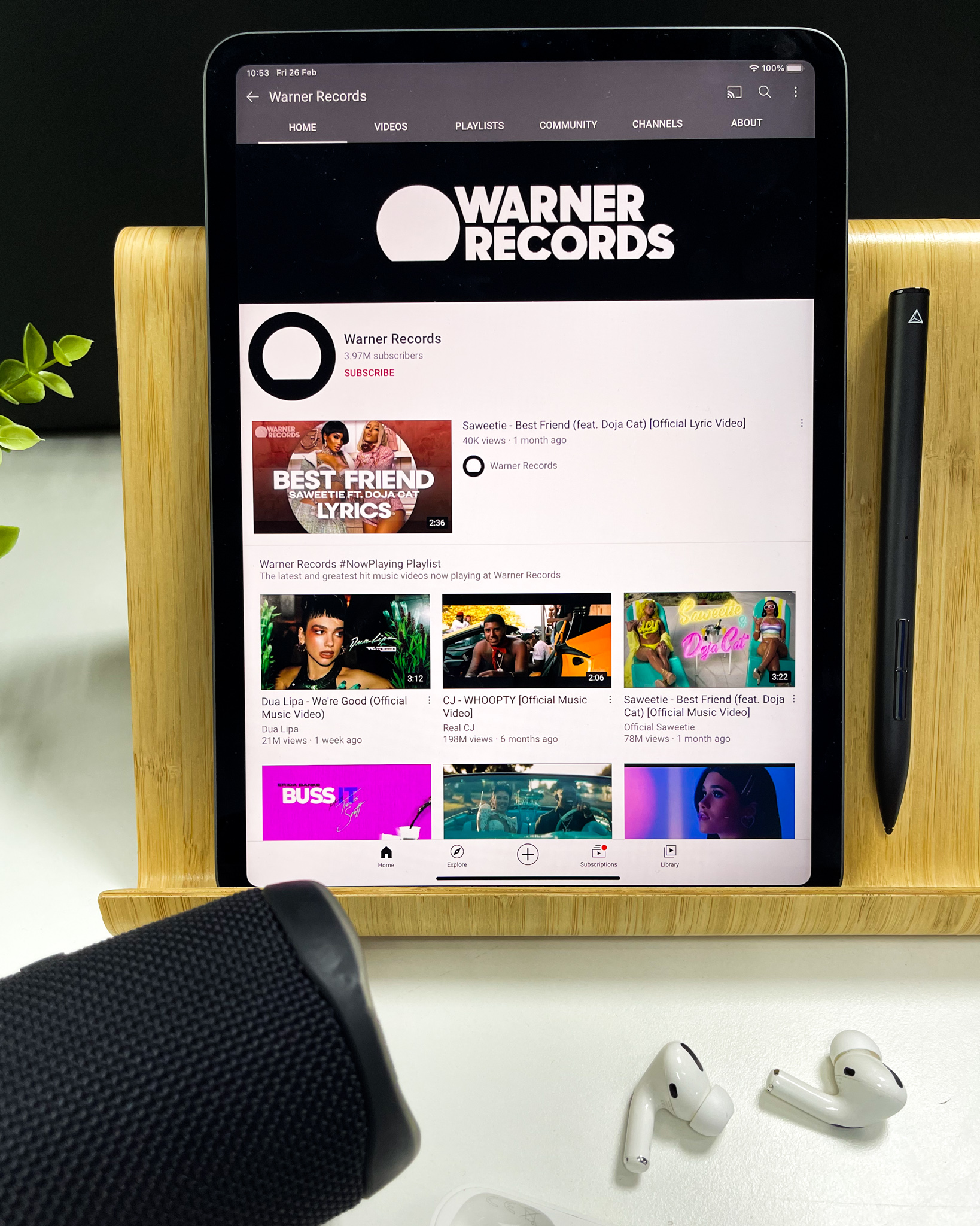 Warner Records on iPad with a JBL speaker and AirPods