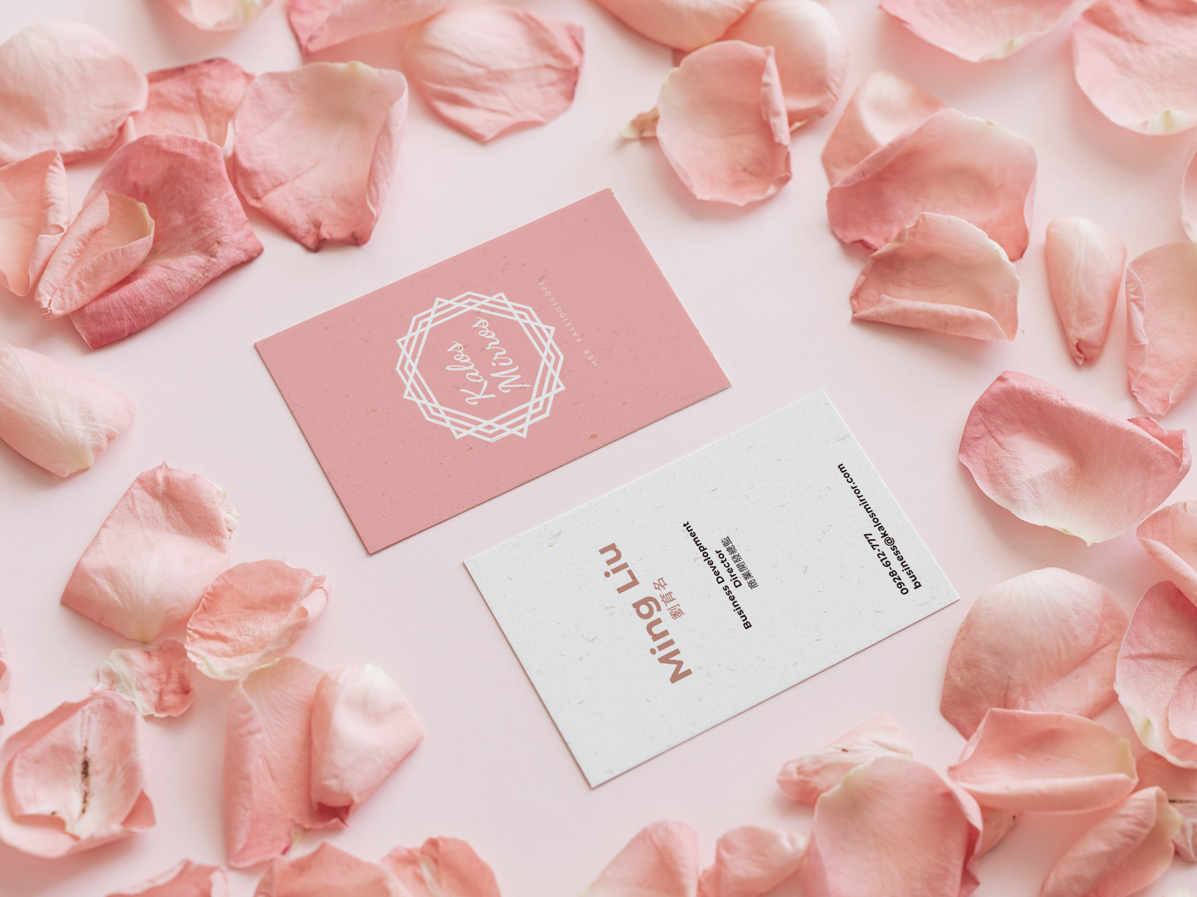 Business cards on a rose-petal flat lay